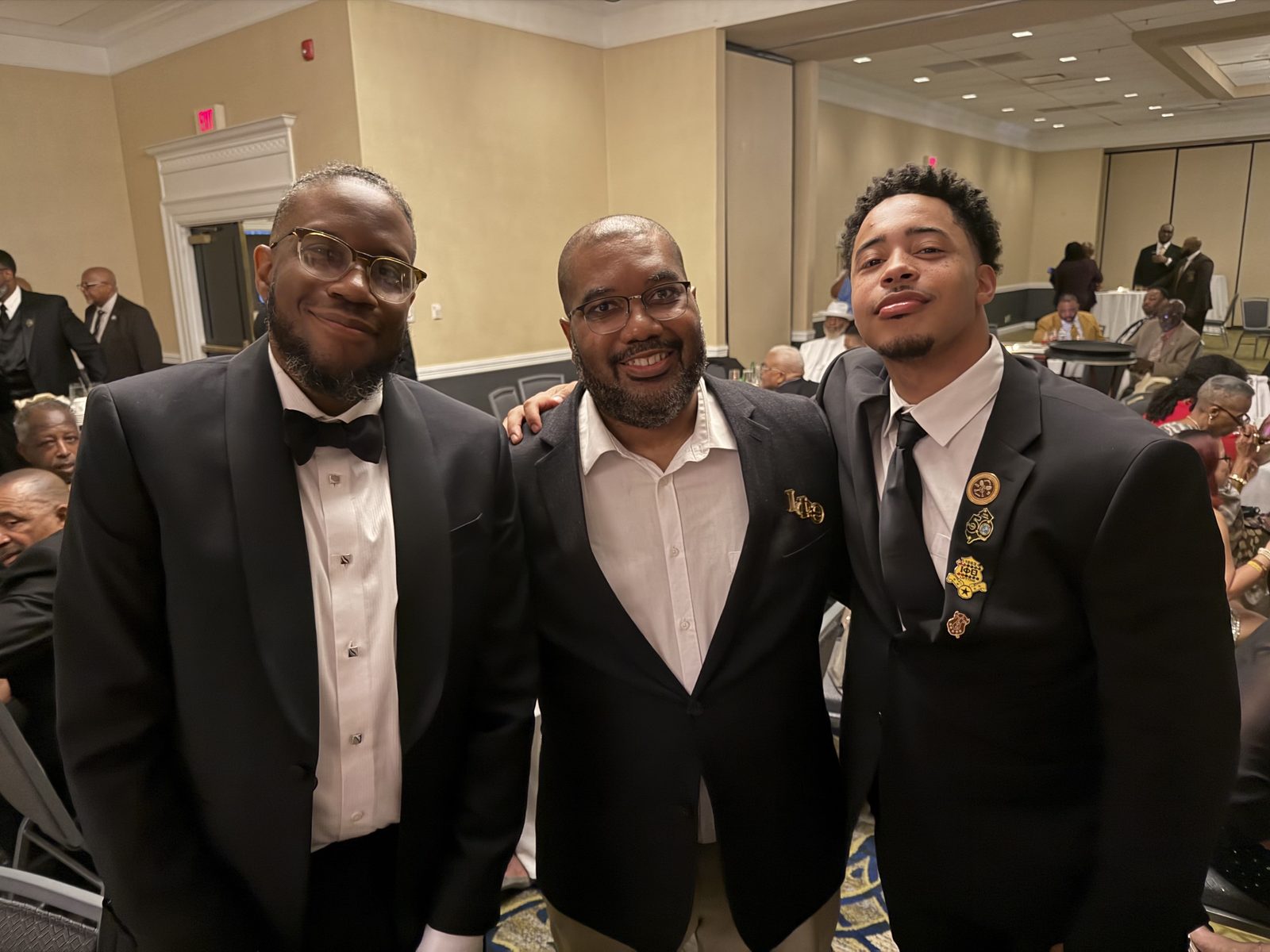 Brothers smiling together at a chapter gala